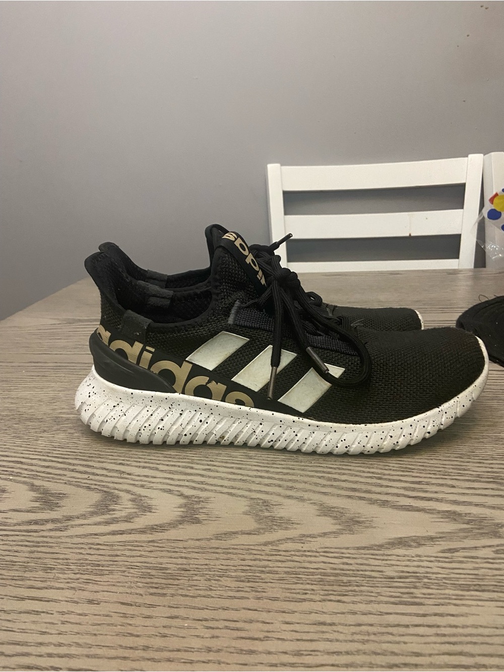 adidas Black Athletic Sneakers with Gold Branding and White Speckled Sole